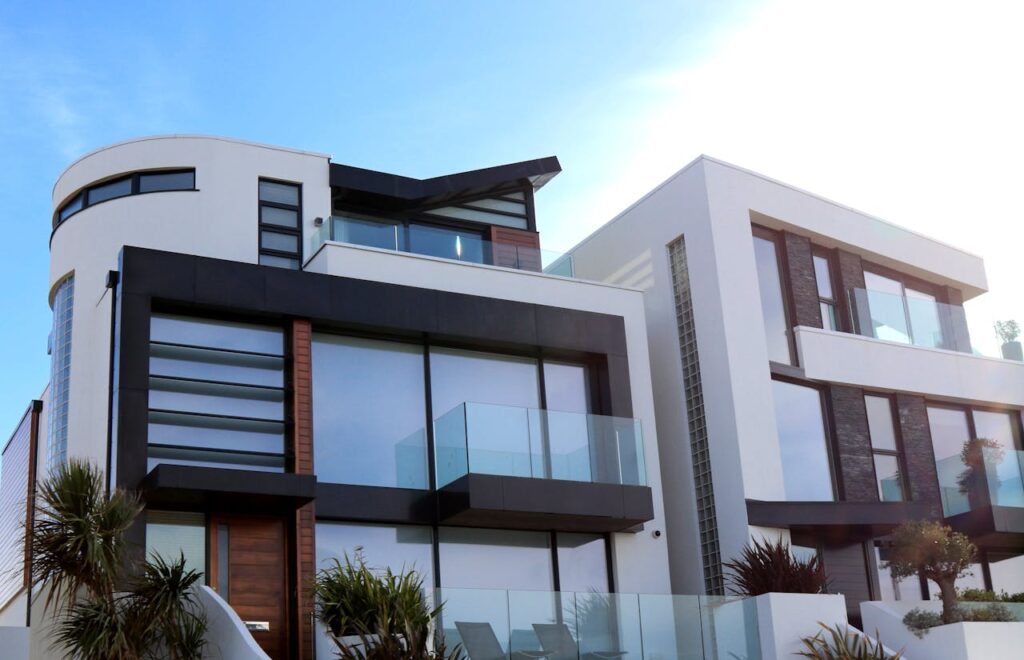 pexels-photo-323780-1 Contemporary luxury home with glass balconies in Poole, UK, showcasing modern architectural design.